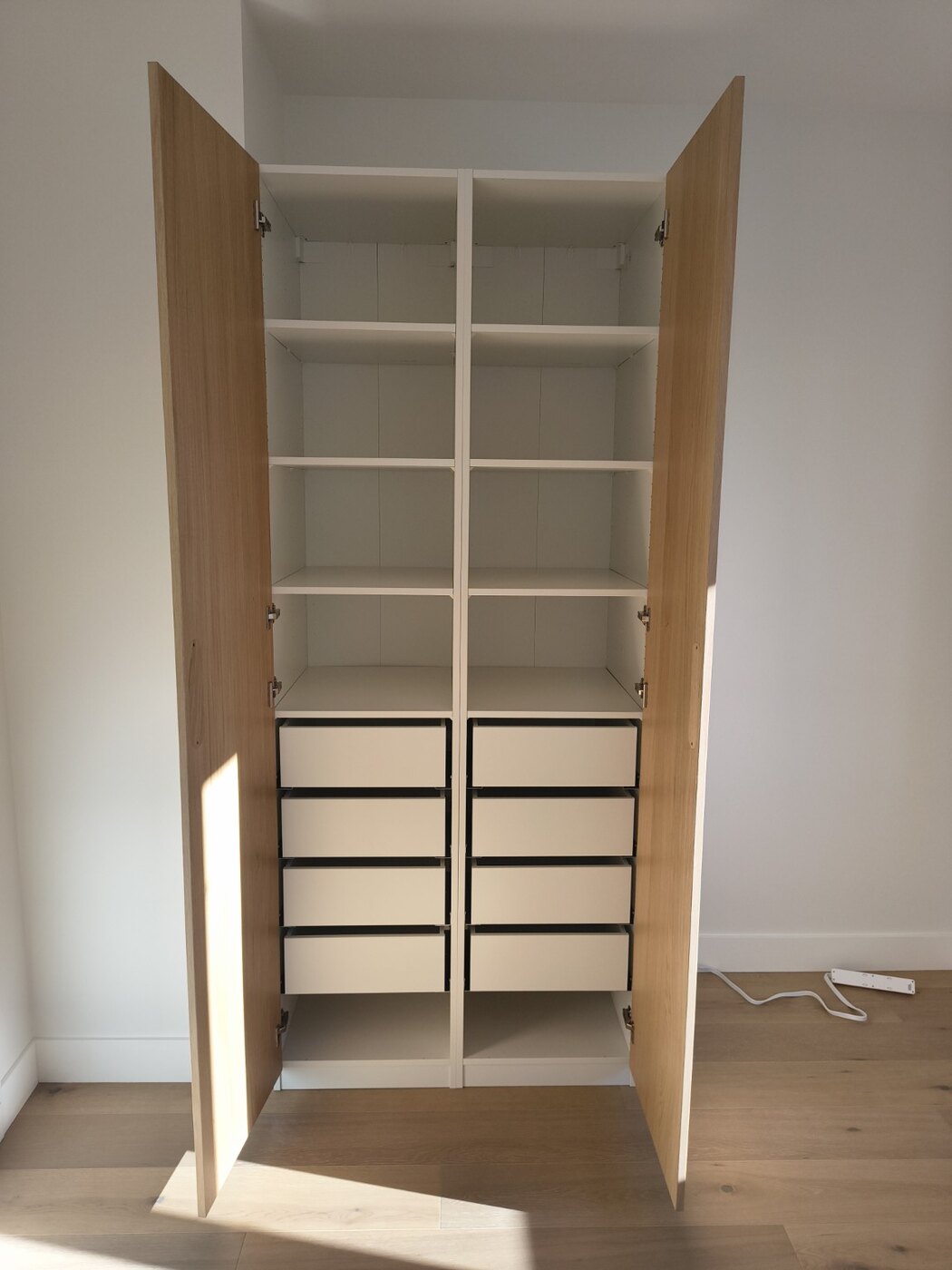 Interior of completed IKEA PAX wardrobe with shelves and drawers