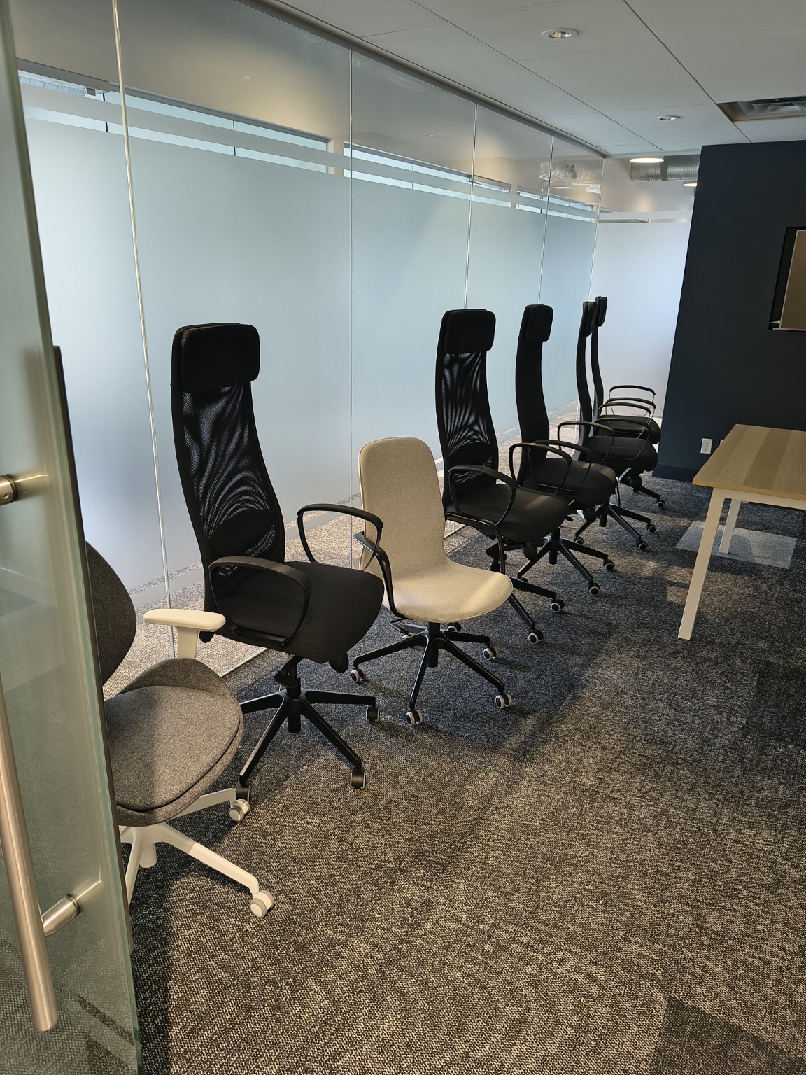 Completed office chairs arranged beside the meeting table